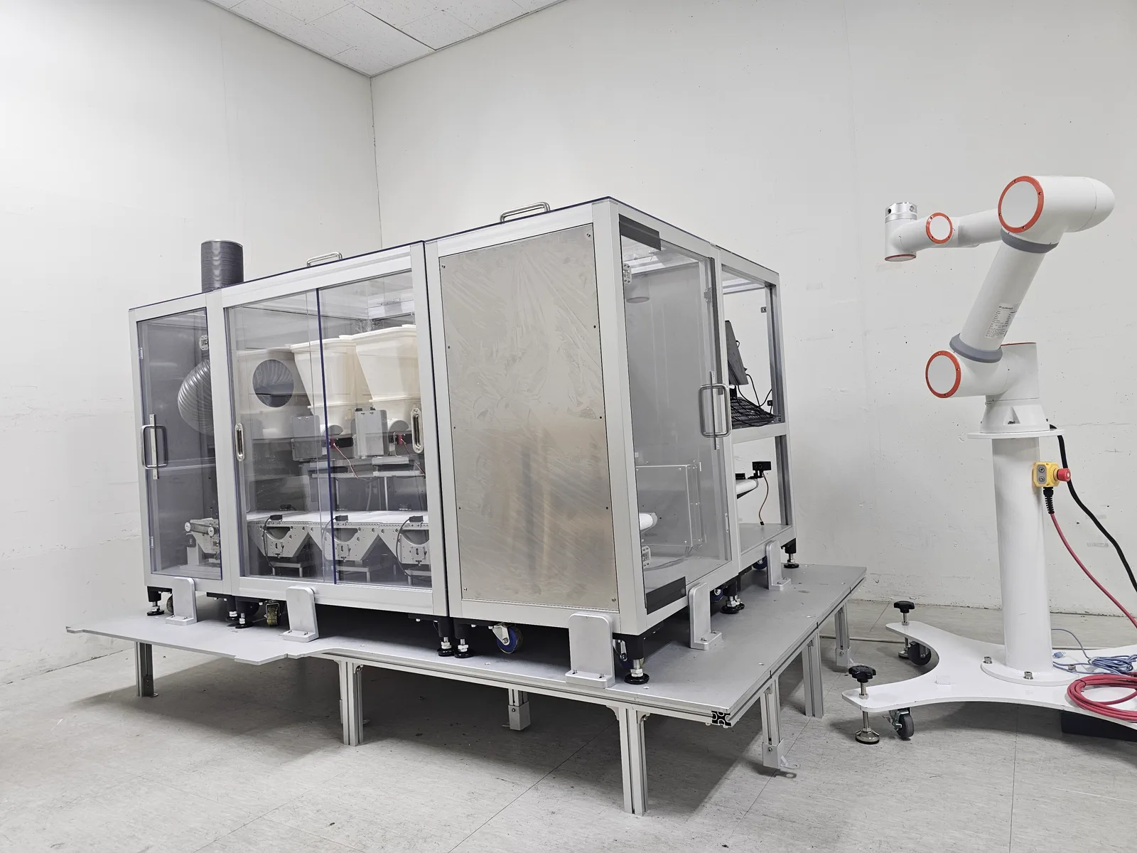 Meal assembly test cell connecting modular dispensers and a six-axis robot